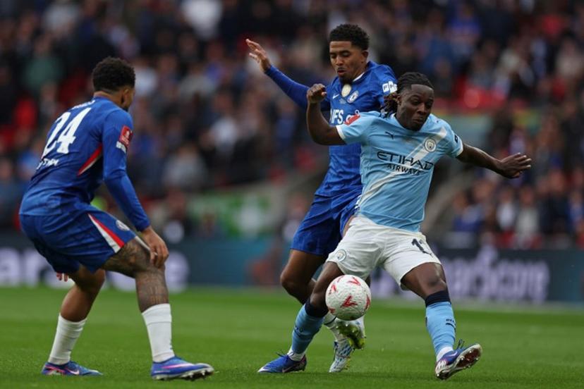 Manchester City's Belgian midfielder #11 Jeremy Doku (R) vies with Chelsea's English defender #24 Reece James (L) and Chelsea's French defender #29 Wesley Fofana (C) during the English FA Cup final football match between Chelsea and Manchester City at Wembley stadium in London, on May 16, 2026.  Adrian Dennis / AFP