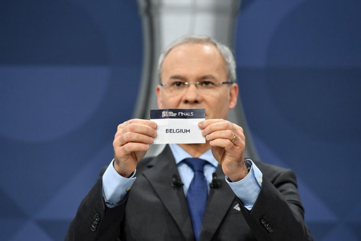 In this handout picture taken and made available by the UEFA on December 3, 2020 UEFA Deputy General Secretary Giorgio Marchetti draws out the card of Belgium during the 2021 UEFA Nations League finals draw in Nyon to decide the semi-final fixtures set to take place next October.  Harold Cunningham / UEFA / AFP