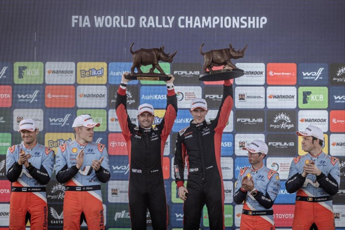 (From L to R) Hyundai Shell Mobis WRT's Estonian co-driver Martin Jarveoja and driver Ott Tanak, Toyota Gazoo Racing WRT's British co-driver Scott Martin and driver Elfyn Evans, and Hyundai Shell Mobis WRT's Belgian co-driver Martijn Wydaeghe and driver Thierry Neuville celebrate on the podium after completing the World Rally Championship (WRC) Safari Rally Kenya in Naivasha on March 23, 2025.  Luis TATO / AFP