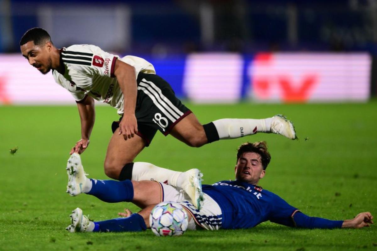 Manchester United's Belgian midfielder #18 Youri Tielemans (L) is tackled by Como's Croatian midfielder #20 Martin Baturina during the UEFA Champions League, league phase matchday 3, football match between Como 1907 and Manchester United at the Stadio Giuseppe Sinigaglia in Como, northen Italy on October 21, 2026.  Marco BERTORELLO / AFP