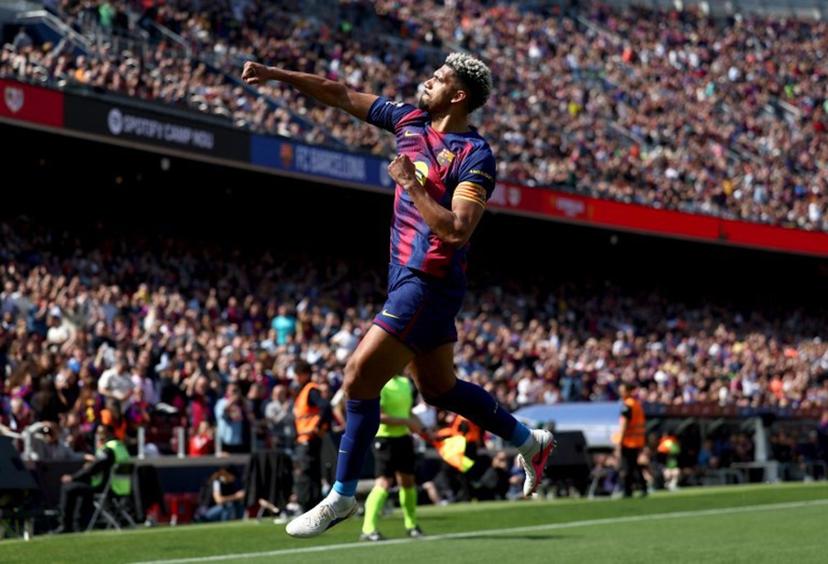 Barcelona's Uruguayan defender #04 Ronald Federico Araujo da Silva celebrates scoring his team's first goal during the Spanish league football match between FC Barcelona and Rayo Vallecano de Madrid at Camp Nou Stadium in Barcelona on March 22, 2026.  Josep LAGO / AFP