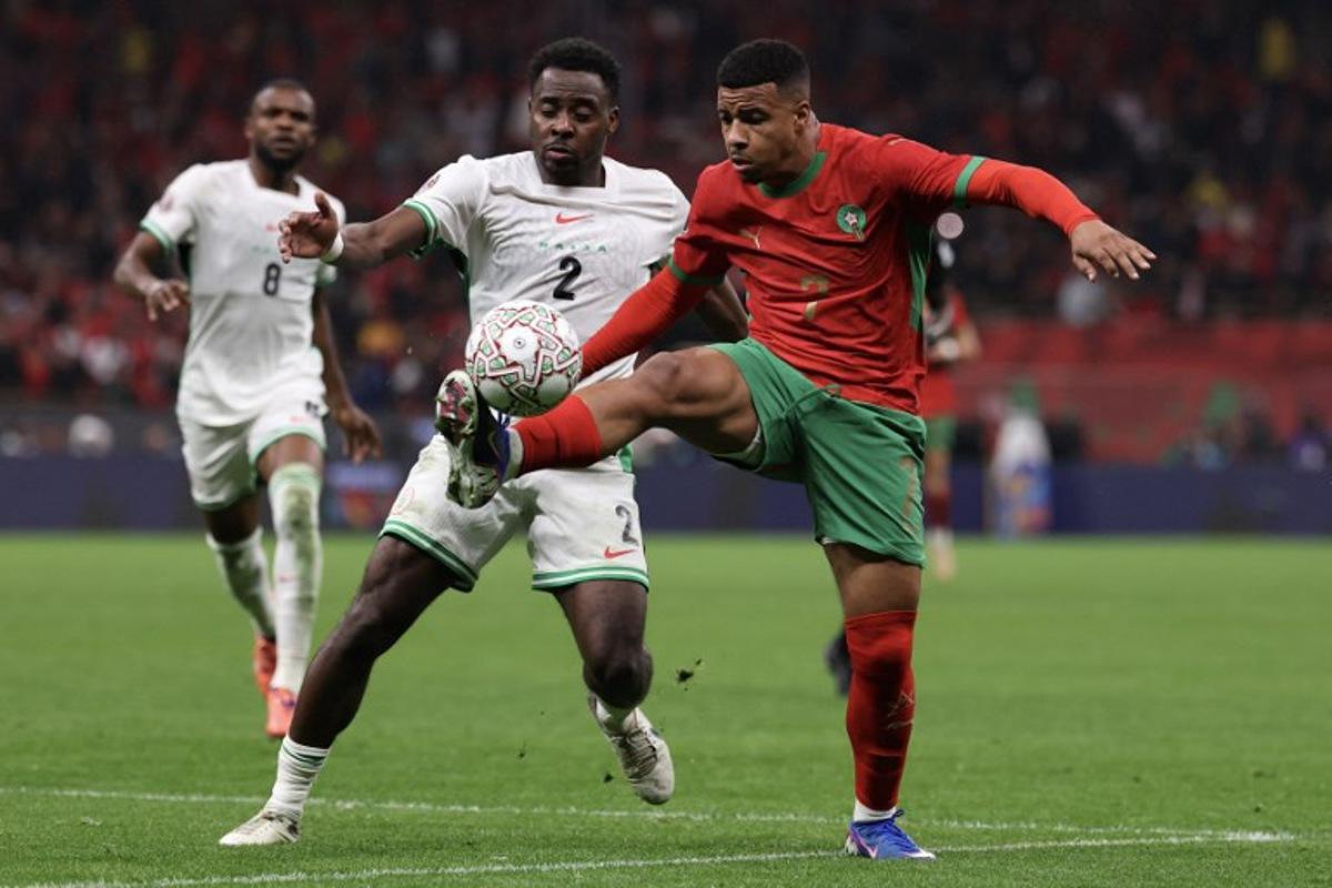 Nigeria's defender #02 Bright Osayi-Samuel and Morocco's forward #07 Hamza Igamane fight for the ball during the Africa Cup of Nations (CAN) semi-final football match between Nigeria and Morocco at the Prince Moulay Abdellah stadium in Rabat on January 14, 2026.   FRANCK FIFE / AFP