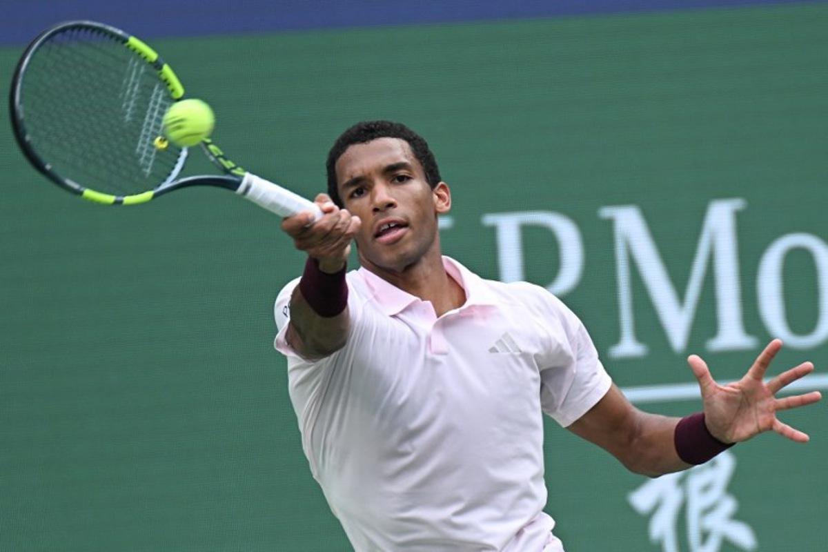 Canada's Felix Auger-Aliassime hits a return to Spain's Pablo Carreno Busta during their men's singles match at the Shanghai Masters tennis tournament in Shanghai on October 12, 2026.  CN-STR / AFP