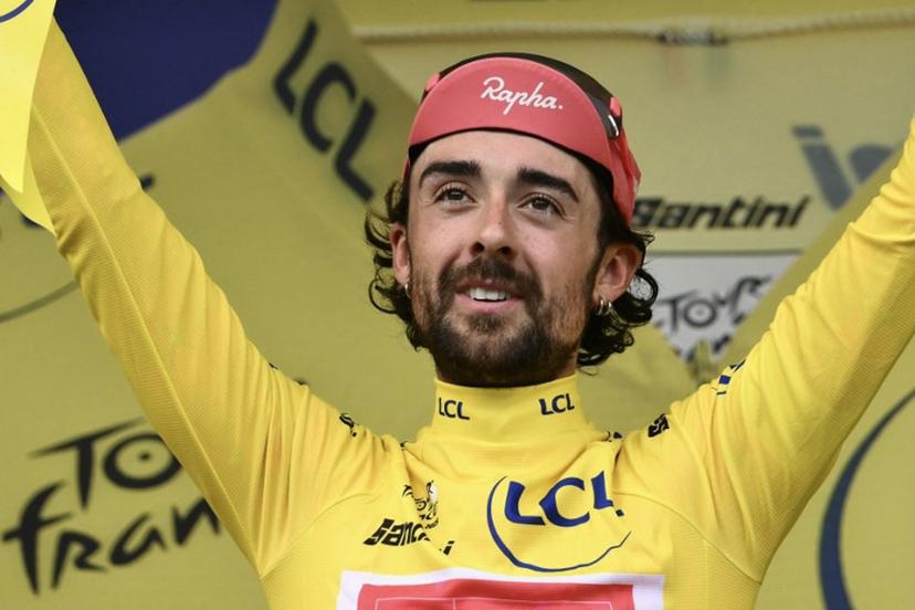 Guest and EF Education - EasyPost team's Irish rider Ben Healy celebrates on the podium with the overall leader's yellow jersey after the 10th stage of the 112th edition of the Tour de France cycling race, 165.3 km between Ennezat and Le Mont-Dore Puy de Sancy, in central France, on July 14, 2025.  Marco BERTORELLO / AFP