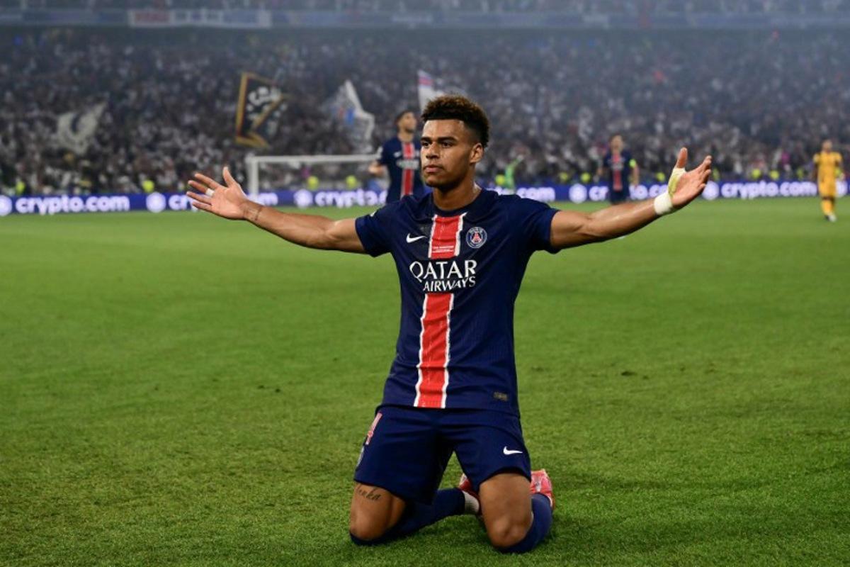 Paris Saint-Germain's French midfielder #14 Desire Doue celebrates after scoring during the UEFA Champions League final football match between Paris Saint-Germain (PSG) and Inter Milan in Munich, southern Germany on May 31, 2025.   Marco BERTORELLO / AFP