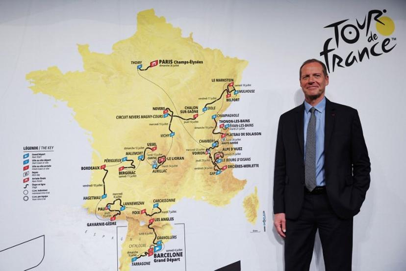 Tour de France General Director Christian Prudhomme poses for a picture in front of the map showing the women's route during the presentation of the official routes of the 2026 edition of the men's and women's Tour de France cycling race in Paris on October 23, 2025.   Anne-Christine POUJOULAT / AFP
