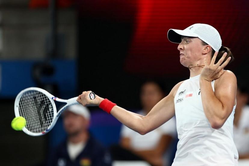 Poland's Iga Swiatek hits a return to Germany's Eva Lys during their women's singles match at the United Cup tennis tournament on Ken Rosewood Arena in Sydney on January 5, 2026.  Izhar KHAN / AFP