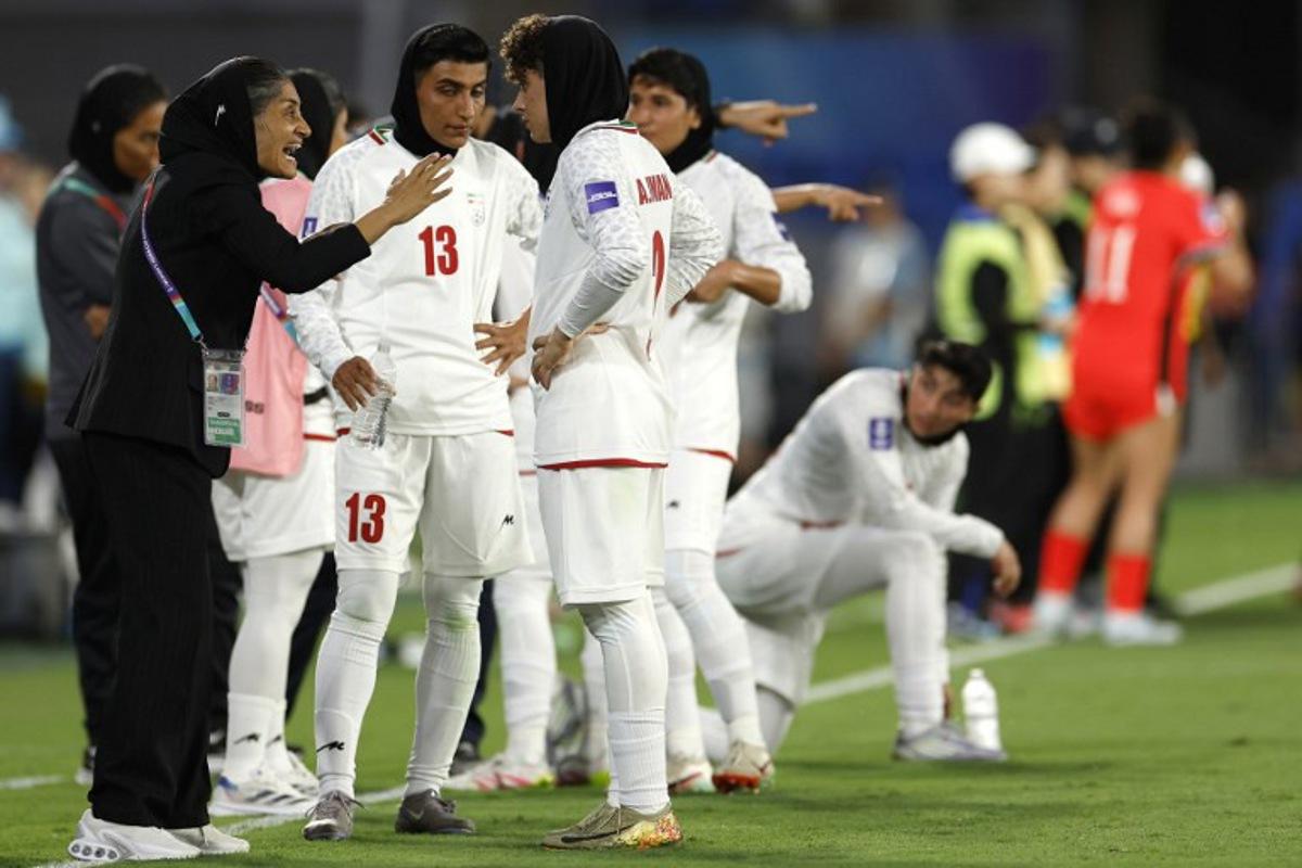 Iran's Head Coach Marziyeh Jafari Baravati (L) gives instructions to players during the AFC Women's Asian Cup Australia 2026 match between South Korea and Iran in Gold Coast on March 2, 2026.  Izhar KHAN / AFP