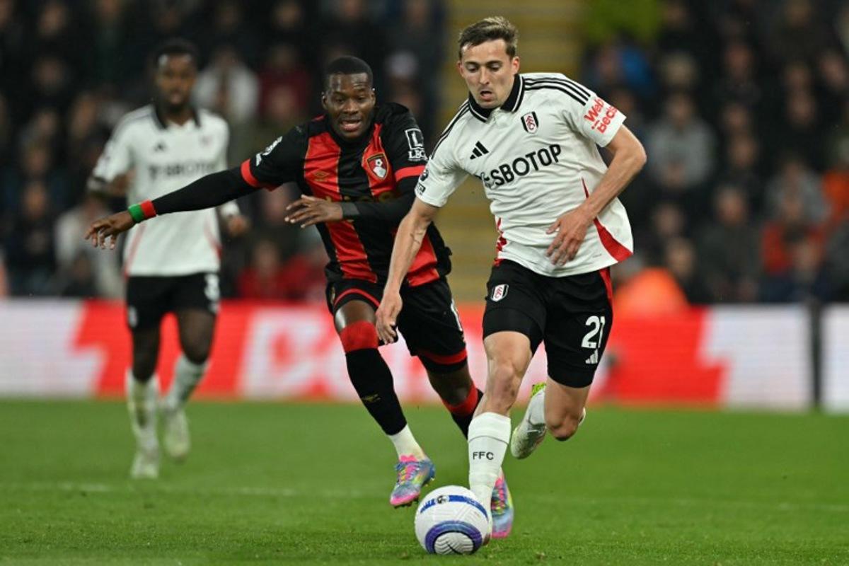 Fulham's Belgian defender #21 Timothy Castagne (R) runs away from Bournemouth's Burkinabe striker #11 Dango Ouattara (L) during the English Premier League football match between Bournemouth and Fulham at the Vitality Stadium in Bournemouth, southern England on April 14, 2025.  Glyn KIRK / AFP