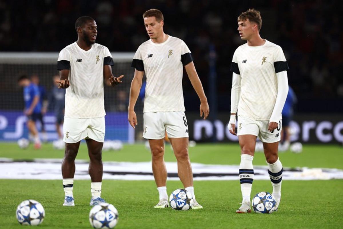 Atalanta's US midfielder #06 Yunus Musah (L), Atalanta's Croatian midfielder #08 Mario Pasalic (C) and Atalanta's Italian forward #70 Daniel Maldini (R) talk during the warm up ahead of the UEFA Champions League first round day 1 football match between Paris Saint-Germain (FRA) and Atalanta (ITA) at the Parc des Princes stadium in Paris on September 17, 2025.  FRANCK FIFE / AFP