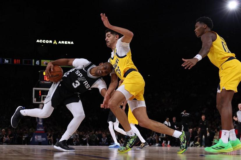 San Antonio Spurs' US guard #03 Chris Paul (L) dribbles the ball as Indiana Pacers' US guard #26 Ben Sheppard (C) defends during the NBA basketball game between the San Antonio Spurs and the Indiana Pacers at the Accor Arena - Palais Omnisports de Paris-Bercy - in Paris on January 25, 2025.   FRANCK FIFE / AFP