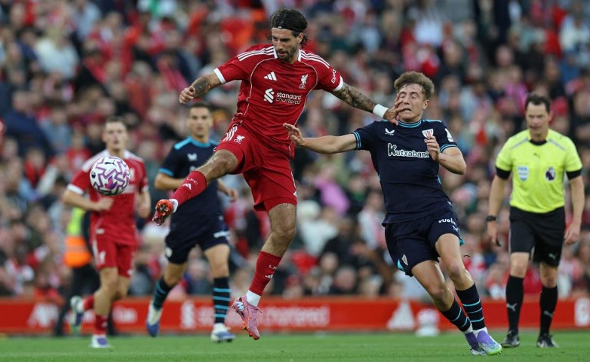 Liverpool's Hungarian midfielder #08 Dominik Szoboszlai (C) vies with Athletic Bilbao's Spanish midfielder #18 Mikel Jauregizar Alboniga during the second of two pre season friendly football matches between Liverpool and Athletic Bilbao at Anfield in Liverpool, north west England on August 4, 2025.  Darren Staples / AFP