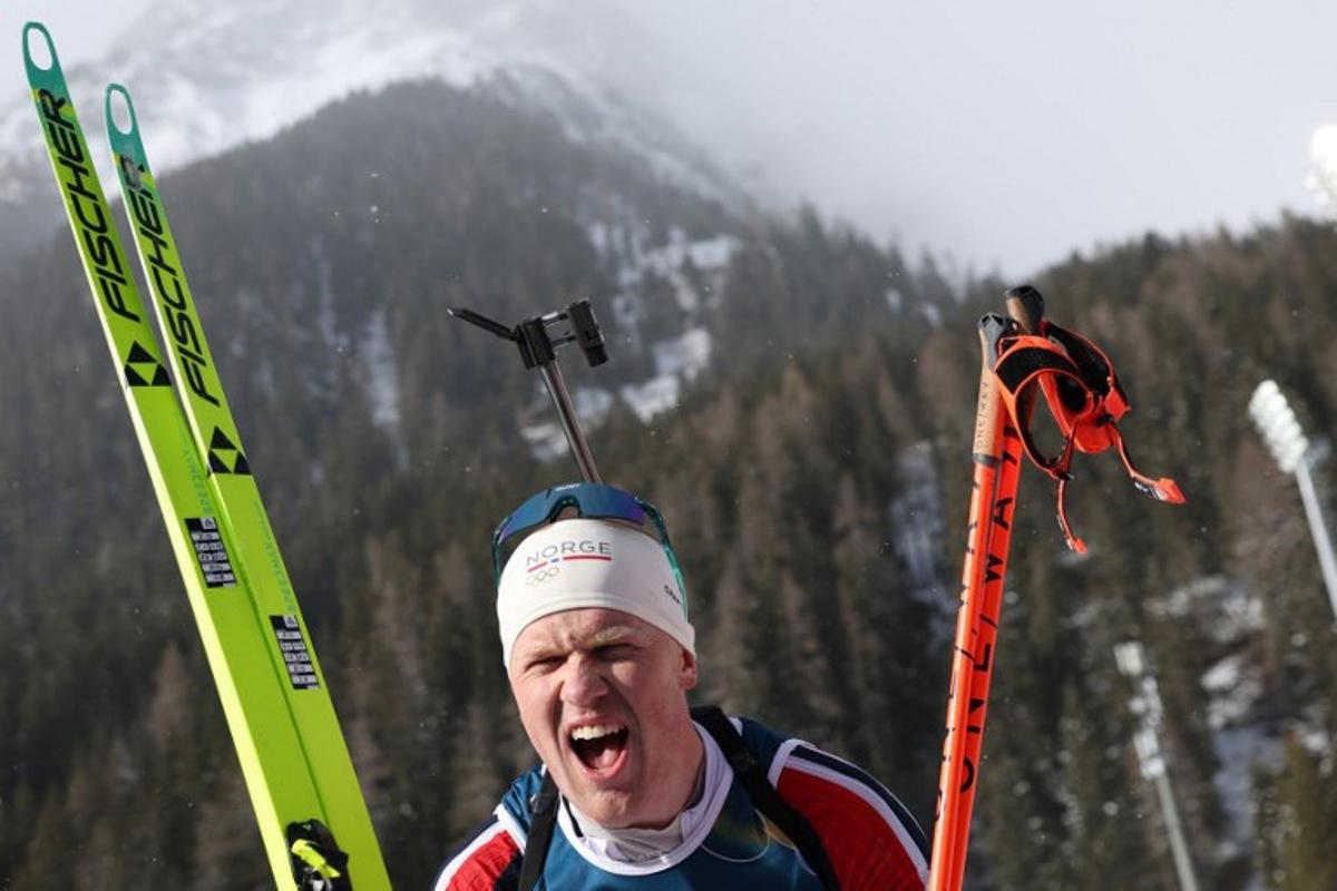 Norway's Johannes Dale-Skjevdal celebrates after he crossed the finish line to win gold during the men's biathlon 15km mass start event during the Milano Cortina 2026 Winter Olympic Games at the Anterselva Biathlon Arena (Sudtirol Arena) in Anterselva (Val Pusteria) on February 20, 2026.  Odd ANDERSEN / AFP