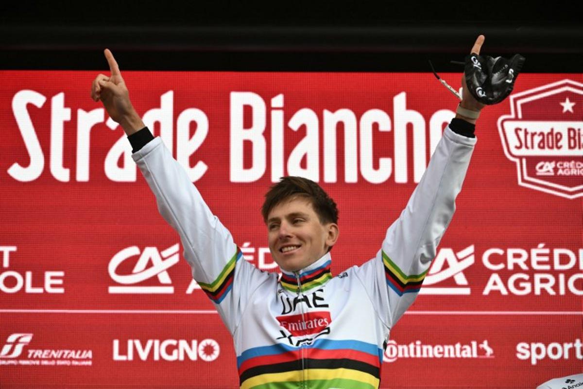 Team UAE's Slovenain rider Tadej Pogacar celebrates on the podium after winning the 19th one-day classic 'Strade Bianche' (White Roads) men's cycling race between Siena and Siena in Tuscany on March 8, 2025.  Marco BERTORELLO / AFP