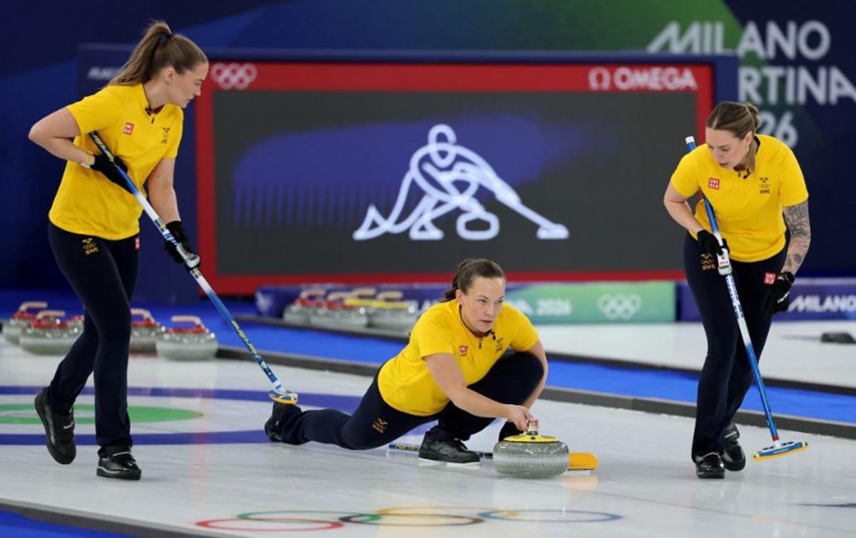 Sweden's Agnes Knochenhauer delivers the stone in the curling women's round robin gold medal game between Switzerland and Sweden during the Milano Cortina 2026 Winter Olympic Games at the Cortina Curling Olympic Stadium in Cortina d'Ampezzo on February 22, 2026.  Odd ANDERSEN / AFP