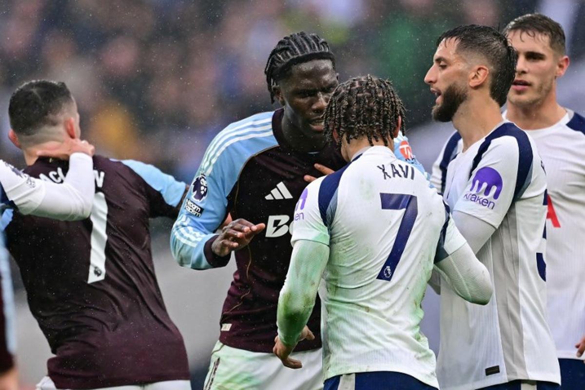 Aston Villa's Belgian midfielder #24 Amadou Onana and Tottenham Hotspur's Dutch midfielder #07 Xavi Simons clash during the English Premier League football match between Tottenham Hotspur and Aston Villa at the Tottenham Hotspur Stadium in London, on October 19, 2025.  Ben STANSALL / AFP