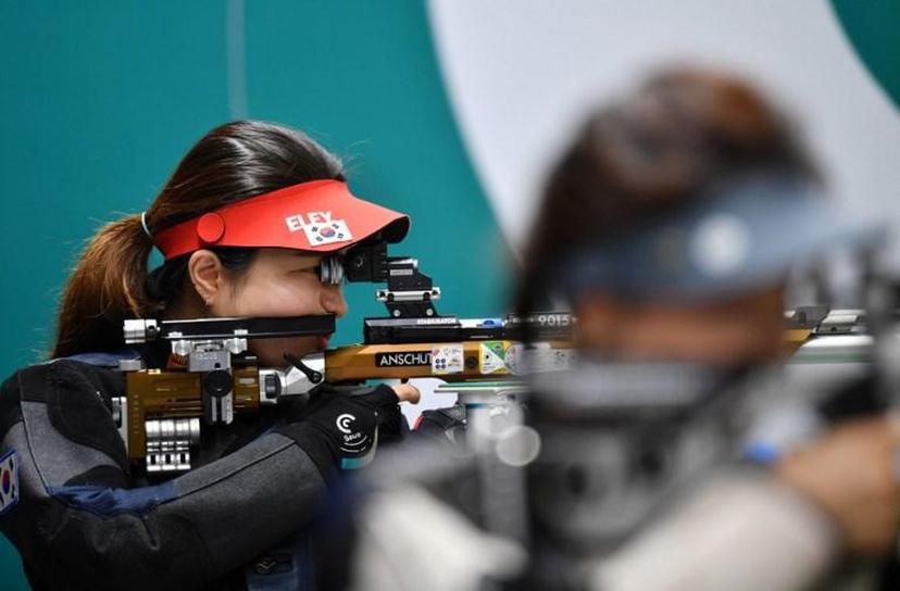 Jung Eunhea (L) of South Korea competes in the final of the women's 10 m air rifle at the 2018 Asian Games in Palembang on August 20, 2018.   ADEK BERRY / AFP