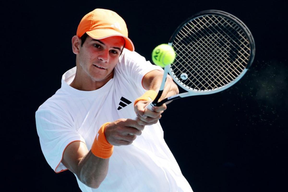 This handout picture released by Tennis Australia on January 22, 2026, shows Spain's Rafael Jodar hits a return to Czech Republic's Jakub Mensik during their men's singles match on day five of the Australian Open tennis tournament in Melbourne.   HAMISH BLAIR / TENNIS AUSTRALIA / AFP