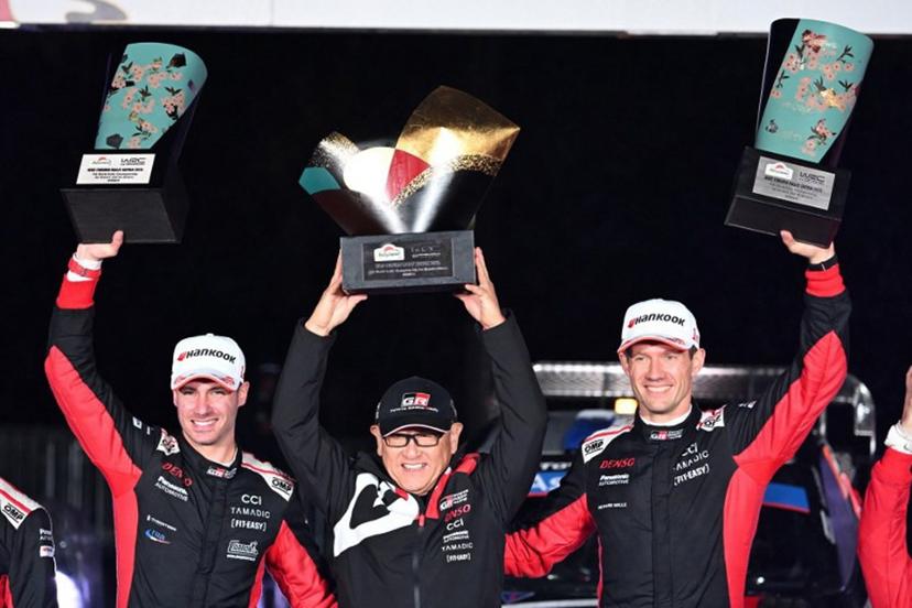Sebastien Ogier (R) and his co-driver Vincent Landais (L) of France celebrate their victory with Toyota Gazoo Racing chairman Akio Toyoda (C) during the podium ceremony of the Rally Japan, the 13th round of the FIA World Rally Championships, in Toyota city, Aichi prefecture on November 9, 2025.  Toshifumi KITAMURA / AFP