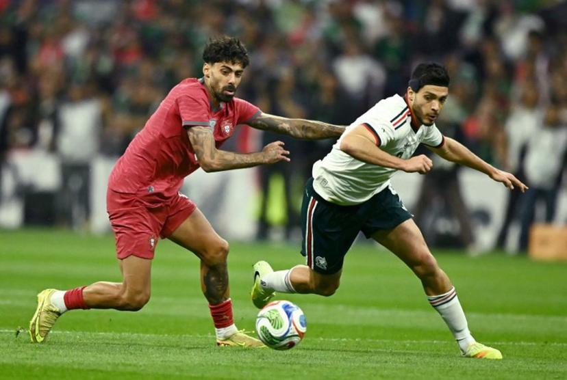 Portugal's defender #05 Samu Costa (L) and Mexico's forward #09 Raul Alonso Jimenez (R) fight for the ball during a friendly football match between Mexico and Portugal at the Banorte (formerly known as Azteca) Stadium in Mexico City on March 28, 2026.  CARL DE SOUZA / AFP