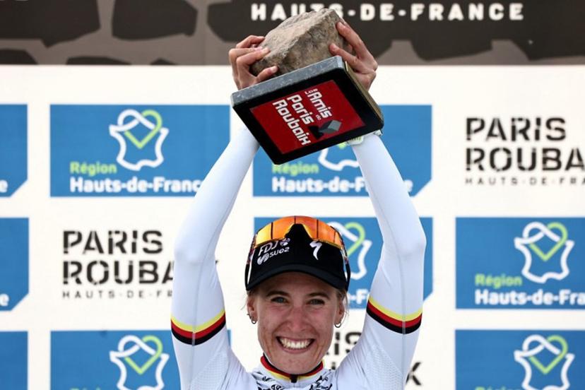 FDJ United-SUEZ's German rider Franziska Koch celebrates winning on the podium of the 6th edition of the Women Paris-Roubaix one-day classic cycling race, 143.1 km between Denain and Roubaix, at the Vélodrome André-Pétrieux in Roubaix, northern France, on April 12, 2026.  Anne-Christine POUJOULAT / AFP