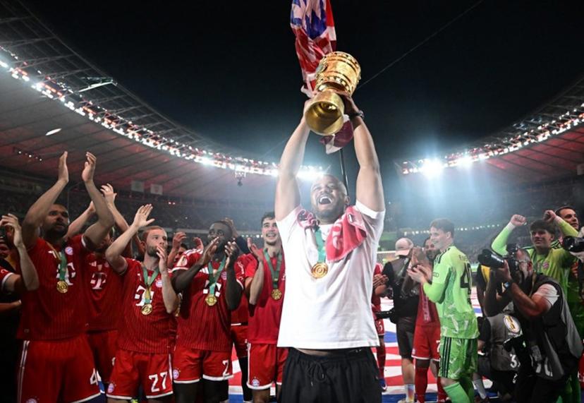 Bayern Munich's Belgian head coach Vincent Kompany lifts the trophy after the German Cup (DFB Pokal) final football match FC Bayern Munich v VfB Stuttgart at the Olympic Stadium in Berlin, on May 23, 2026.  Tobias SCHWARZ / AFP