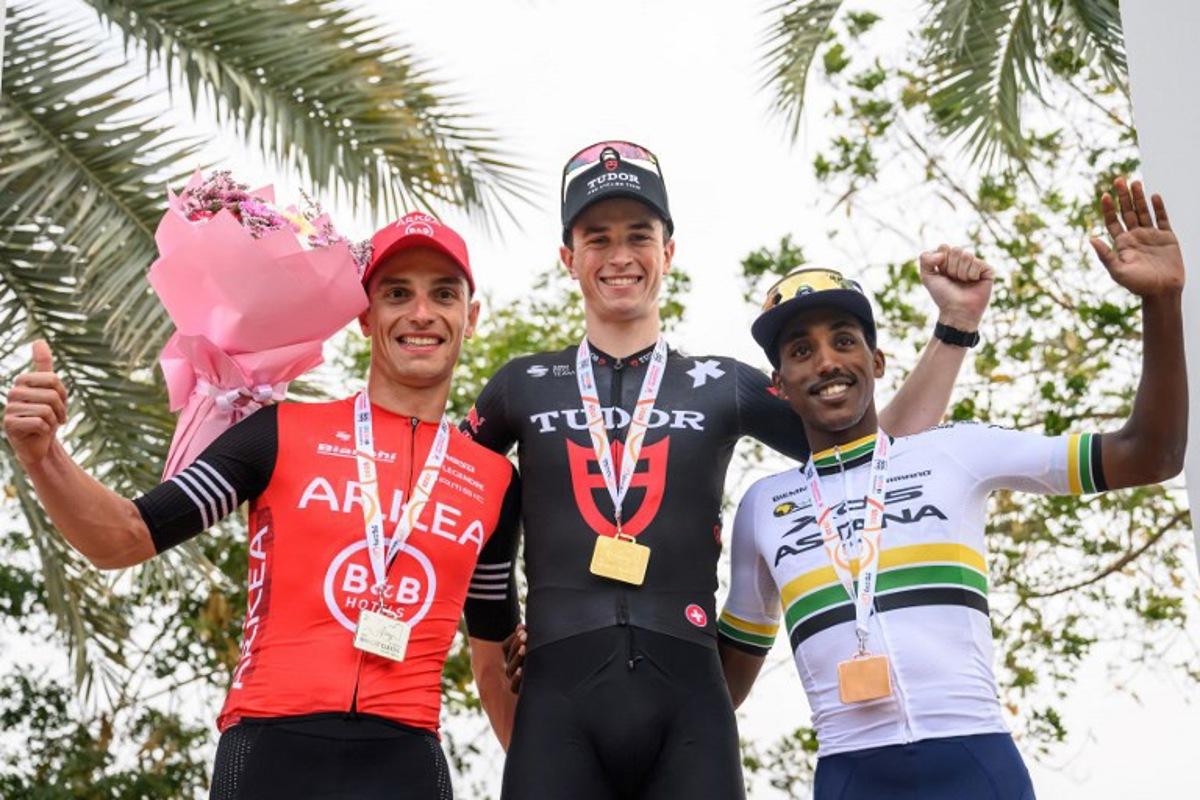 Tudor Pro Cycling Team's Netherland rider Rick Pluimers (C) poses on the podium after winning the Muscat Classic cycling race ahead of second place Arkea B&B Hotels Team's Belgian rider Jenthe Biermans (L), and third place XDS Astana team's Erythrean rider Henok Mulueberhan (R), in Muscat on February 7, 2025.  Loic VENANCE / AFP