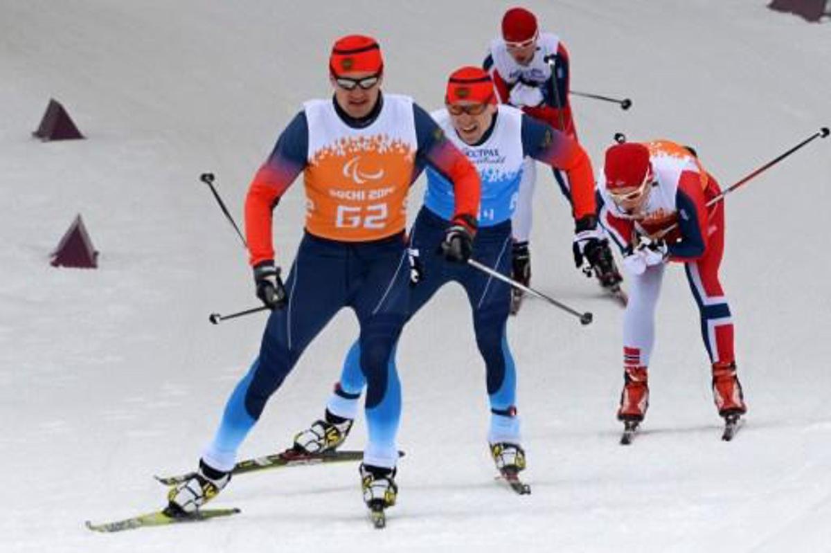 Russia's Nikolay Polukhin (2nd L) and his guide Andrey Tokarev (L), Norway's Eirik Bye (2nd R) and his guide Kristian Myhre Hellerud compete during Cross-country skiing 4x2,5 km Mixed Relay at XI Paralympic Olympic games in the Laura stadium close to city of Sochi on March 15, 2014. AFP PHOTO/KIRILL KUDRYAVTSEV