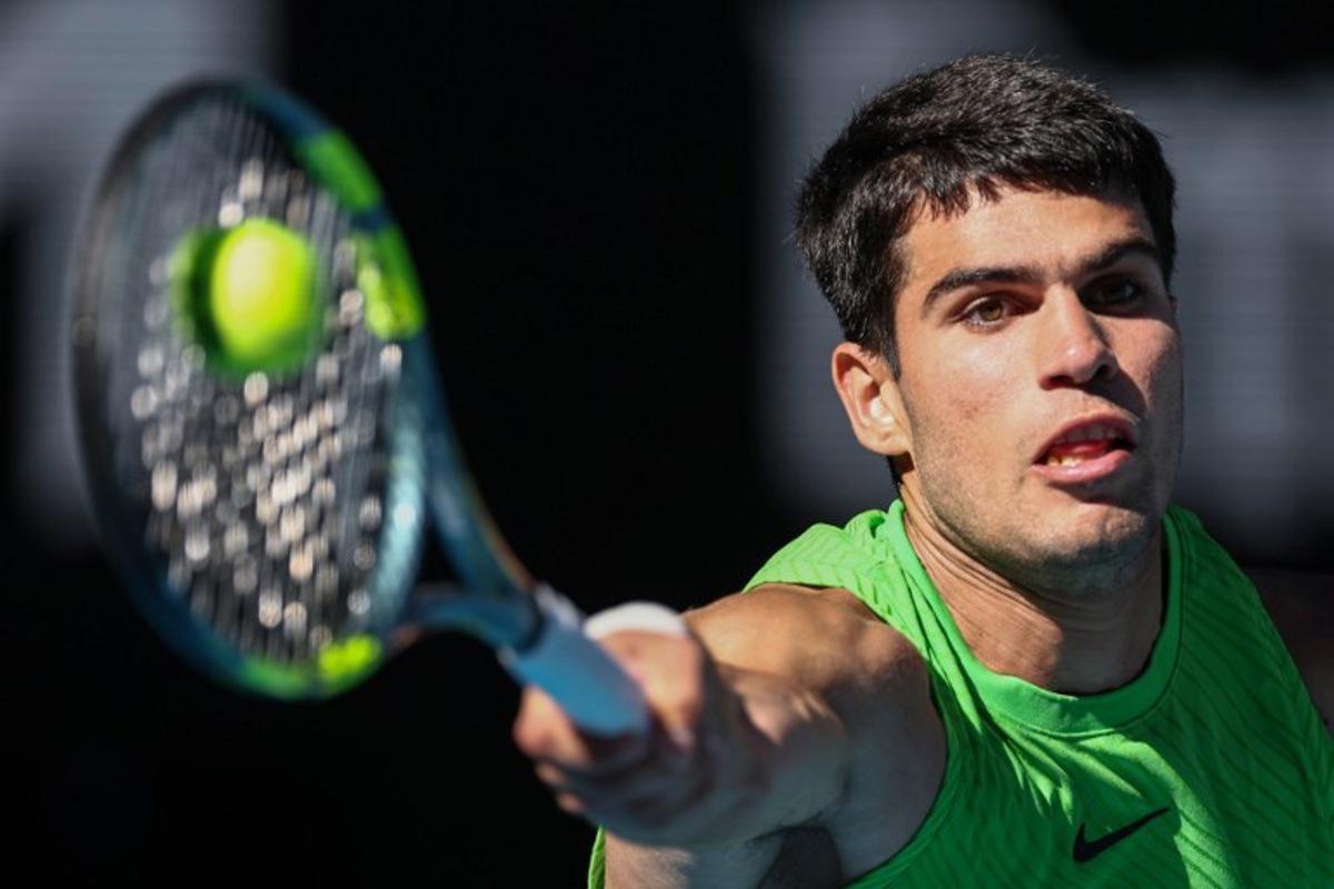 Spain's Carlos Alcaraz hits a return against Germany's Alexander Zverev during their men's singles semi-final match on day thirteen of the Australian Open tennis tournament in Melbourne on January 30, 2026.  IZHAR KHAN / AFP
