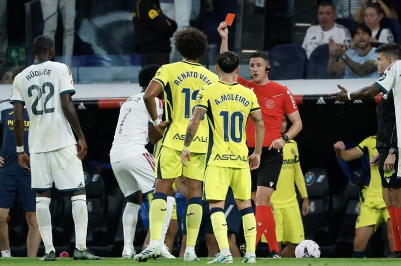 Referee Isidro Escuderos shows a red card to Real Madrid's Brazilian forward #07 Vinicius Junior (2L) during the Spanish league football match between Real Madrid CF and Villarreal CF at the Santiago Bernabeu Stadium in Madrid on October 10, 2026.  Oscar DEL POZO / AFP