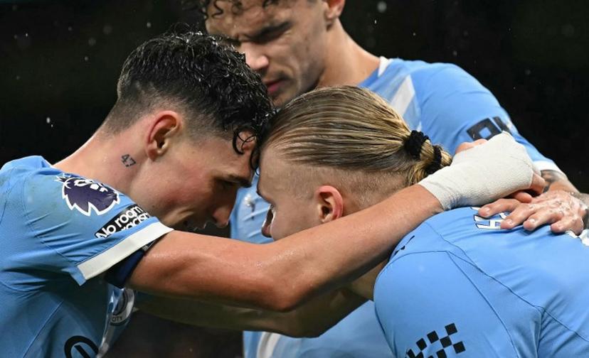 Manchester City's Norwegian striker #09 Erling Haaland (R) celebrates scoring the team's third goal with Manchester City's English midfielder #47 Phil Foden and Manchester City's English midfielder #33 Nico O'Reilly during the English Premier League football match between Manchester City and Fulham at the Etihad Stadium in Manchester, north west England, on February 11, 2026.  Paul ELLIS / AFP