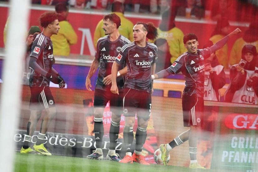 Frankfurt's Moroccan forward #29 Ayoube Amaimouni-Echghouyab celebrates with his team mates after scoring the equalising goal during the German first division Bundesliga football match between VfB Stuttgart and Eintracht Frankfurt in Stuttgart, southern Germany, on January 13, 2026.  THOMAS KIENZLE / AFP