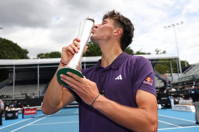 Czech Republic's Jakub Mensik kisses his trophy after victory against Argentina's Sebastian Baez in their men's singles final match at the ATP Auckland Classic tennis tournament in Auckland on January 17, 2026.  Michael Bradley / AFP