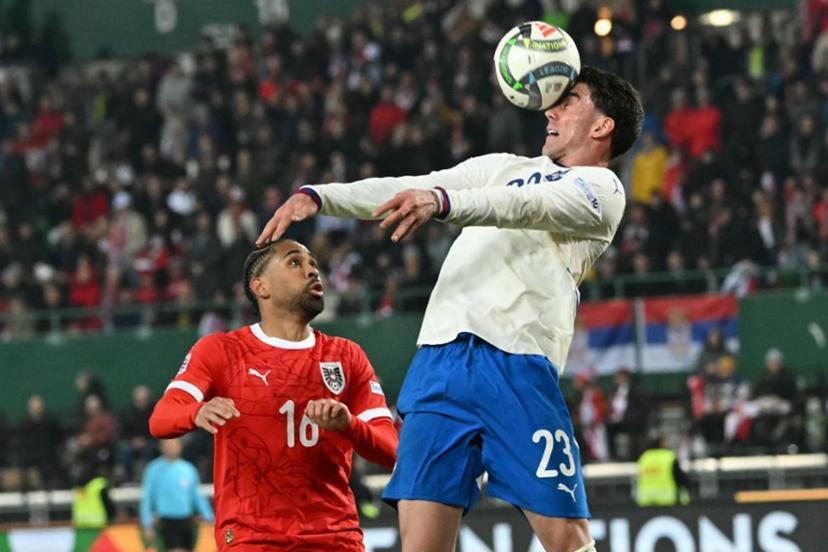 Austria's defender #16 Philipp Mwene and Serbia's forward #23 Dusan Vlahovic vie for the ball during the UEFA Nations League play-off, first-leg football match Austria v Serbia at the Ernst Happel Stadium in Vienna on March 20, 2025.   Joe Klamar / AFP