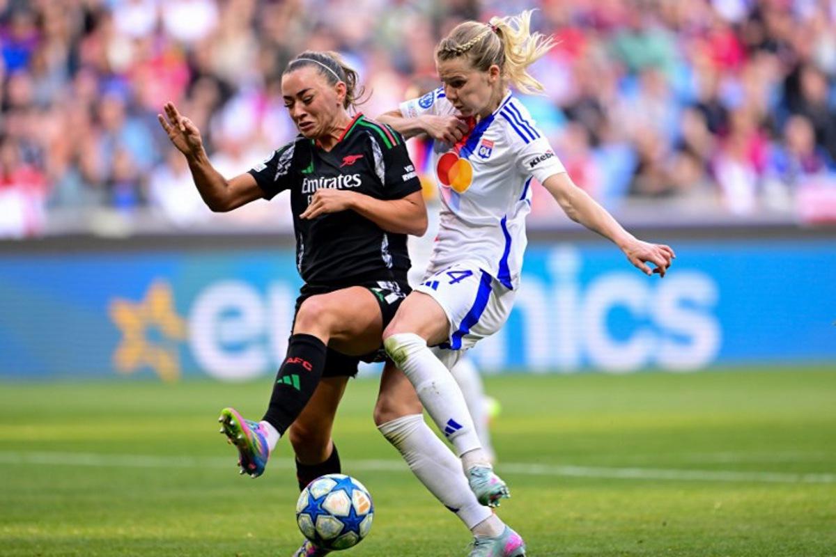 Arsenal's Irish defender #11 Katie McCabe (L) fights for the ball with Lyon's Norway forward #14 Ada Hegerberg (R) during the UEFA Women's Champions League semi-final second leg football match between Lyon and Arsenal at the Groupama Stadium in Decines-Charpieu, central-eastern France on April 27, 2025.  OLIVIER CHASSIGNOLE / AFP