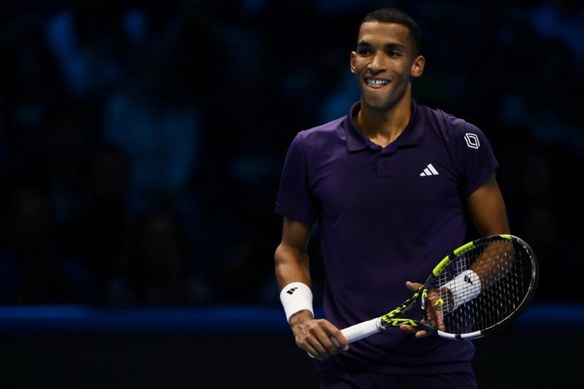 Canada's Felix Auger Aliassime reacts as he plays against Germany's Alexander Zverev during their men's single tennis match at the ATP Finals tennis tournament, in Turin, on November 14, 2025.  MARCO BERTORELLO / AFP