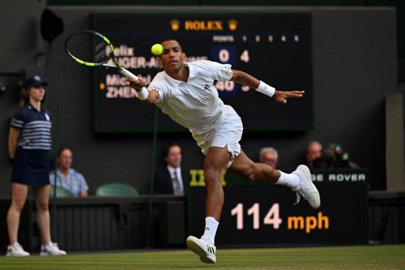 Canada's Felix Auger-Aliassime returns to US player Michael Zheng during their men's singles third round tennis match on the fifth day of the 2026 Wimbledon Championships at The All England Lawn Tennis and Croquet Club in Wimbledon, southwest London, on July 3, 2026.  Glyn KIRK / AFP
