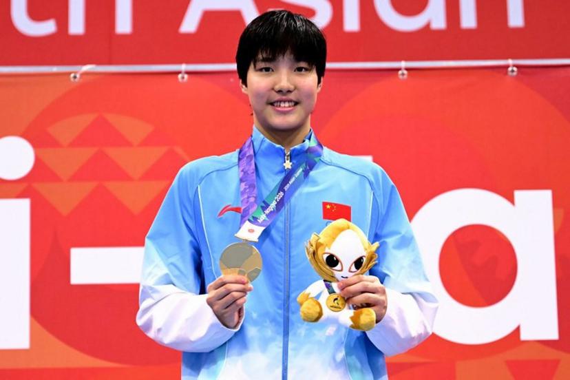 Gold medallist China's Yu Zidi celebrates on the podium during the victory ceremony of the women's 200m butterfly swimming event during the 2026 Asian Games at the Tokyo Aquatics Centre in Tokyo on September 20, 2026.  Yuichi YAMAZAKI / AFP
