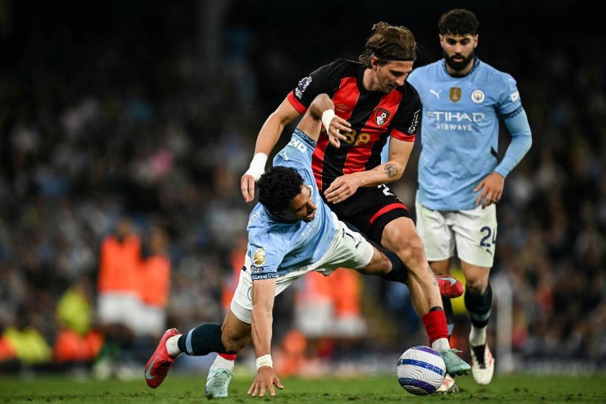 Manchester City's Egyptian striker #07 Omar Marmoush (L) fights for the ball with Bournemouth's Ukrainian defender #27 Illia Zabarnyi (C) during the English Premier League football match between Manchester City and Bournemouth at the Etihad Stadium in Manchester, north west England, on May 20, 2025.  Paul ELLIS / AFP