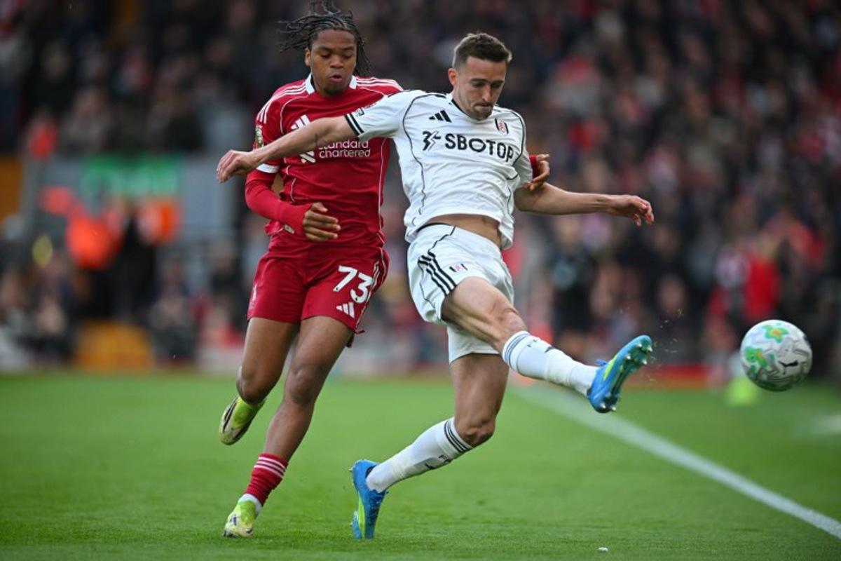 Fulham's Belgian defender #21 Timothy Castagne (R) vies with Liverpool's English striker #73 Rio Ngumoha (L) during the English Premier League football match between Liverpool and Fulham at Anfield in Liverpool, north west England on April 11, 2026.  ANDY BUCHANAN / AFP