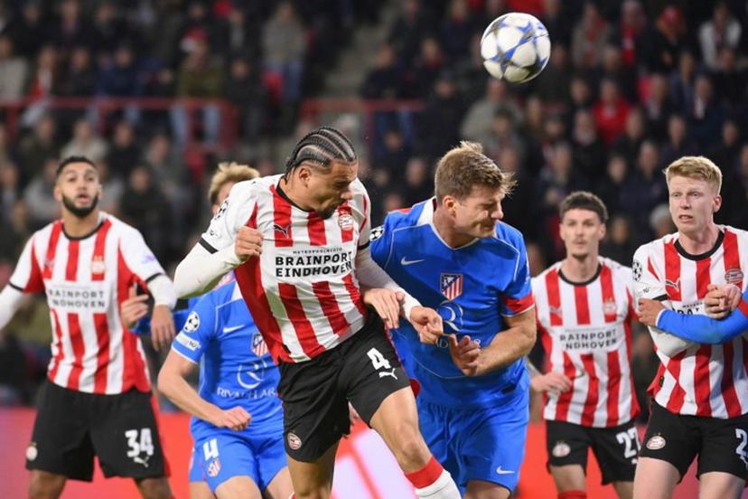 PSV Eindhoven's Dutch defender #04 Armando Obispo heads the ball during the UEFA Champions League, league phase day 6, football match between PSV Eindhoven (NED) and Atletico Madrid (ESP), at the Philips Stadion, in Eindhoven, south of The Netherlands, on December 9, 2025.  JOHN THYS / AFP