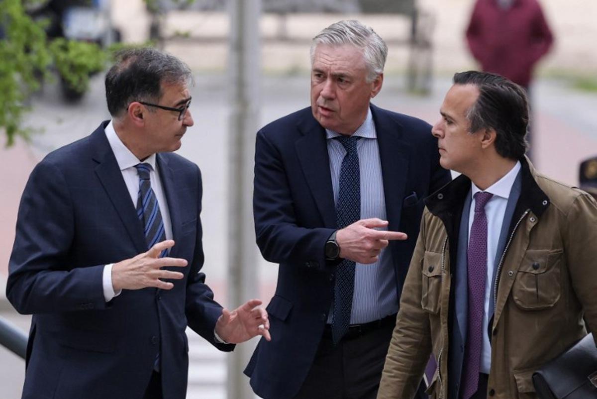 Real Madrid's Italian coach Carlo Ancelotti (C) arrives to the High Court of Justice of Madrid to go on trial accused of tax evasion of 1 million euros, the latest in a string of such cases targeting sports figures in the country, in Madrid, on April 2, 2025. Prosecutors are seeking a jail term of four years and nine months for the 65-year-old Italian, accusing him of costing Spain's treasury more than one million euros ($1.1 million) in undeclared earnings from image rights in 2014 and 2015. Ancelotti is accused of only declaring in his tax returns the personal remuneration received from Real Madrid during those two years even though he declared himself a tax resident in Spain and indicated his home was in Madrid.  Thomas COEX / AFP