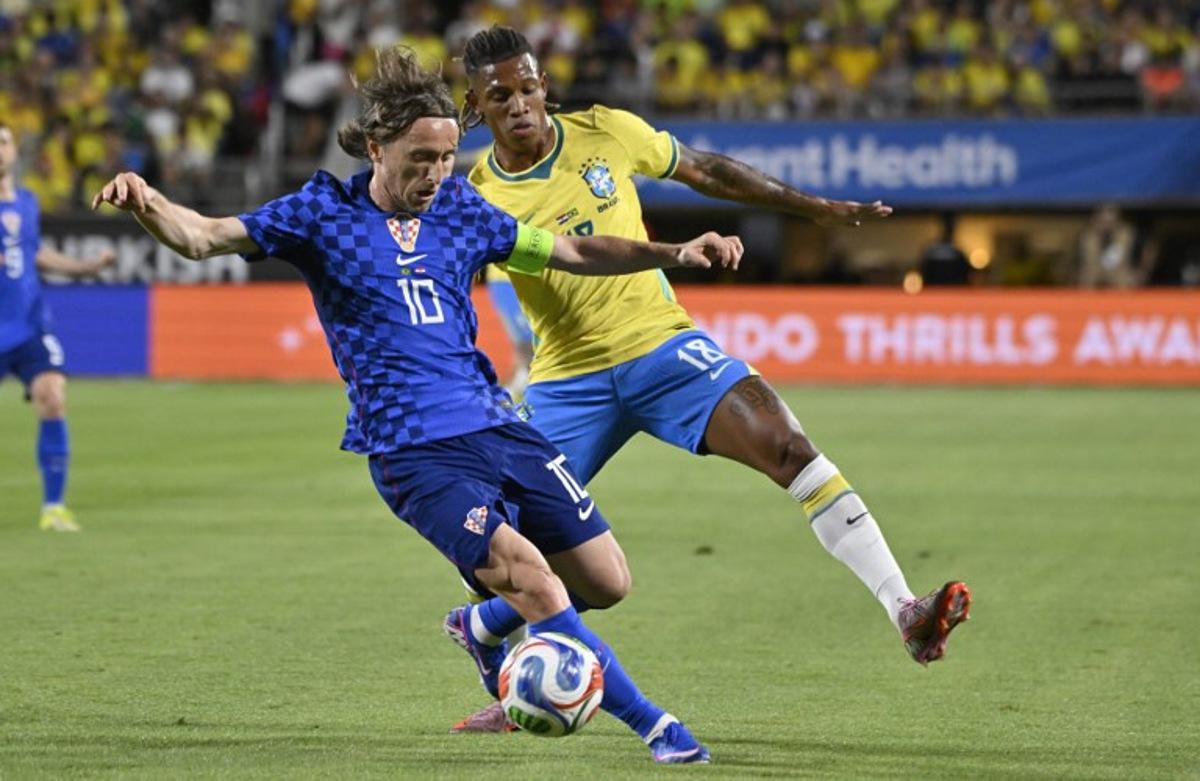 Croatia's midfielder #10 Luka Modric and Brazil's midfielder #18 Danilo De Oliveira vie for the ball during a friendly football match between Brazil and Croatia at Camping World Stadium in Orlando, Florida, on March 31, 2026.  MIGUEL J RODRIGUEZ CARRILLO / AFP
