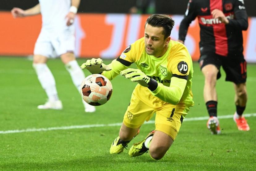 West Ham United's Polish goalkeeper #01 Lukasz Fabianski saves the ball during the UEFA Europa League quarter-final first leg football match between Bayer 04 Leverkusen and West Ham United FC in Leverkusen, western Germany on April 11, 2024.  INA FASSBENDER / AFP