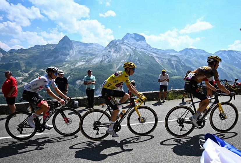 UAE Team Emirates team's Slovenian rider Tadej Pogacar (L) wearing the best young rider's white jersey, Jumbo-Visma team's Danish rider Jonas Vingegaard wearing the overall leader's yellow jersey and Jumbo-Visma team's American rider Sepp Kuss cycle during the 18th stage of the 109th edition of the Tour de France cycling race, 143,2 km between Lourdes and Hautacam in the Pyrenees mountains in southwestern France, on July 21, 2022.  Anne-Christine POUJOULAT / AFP