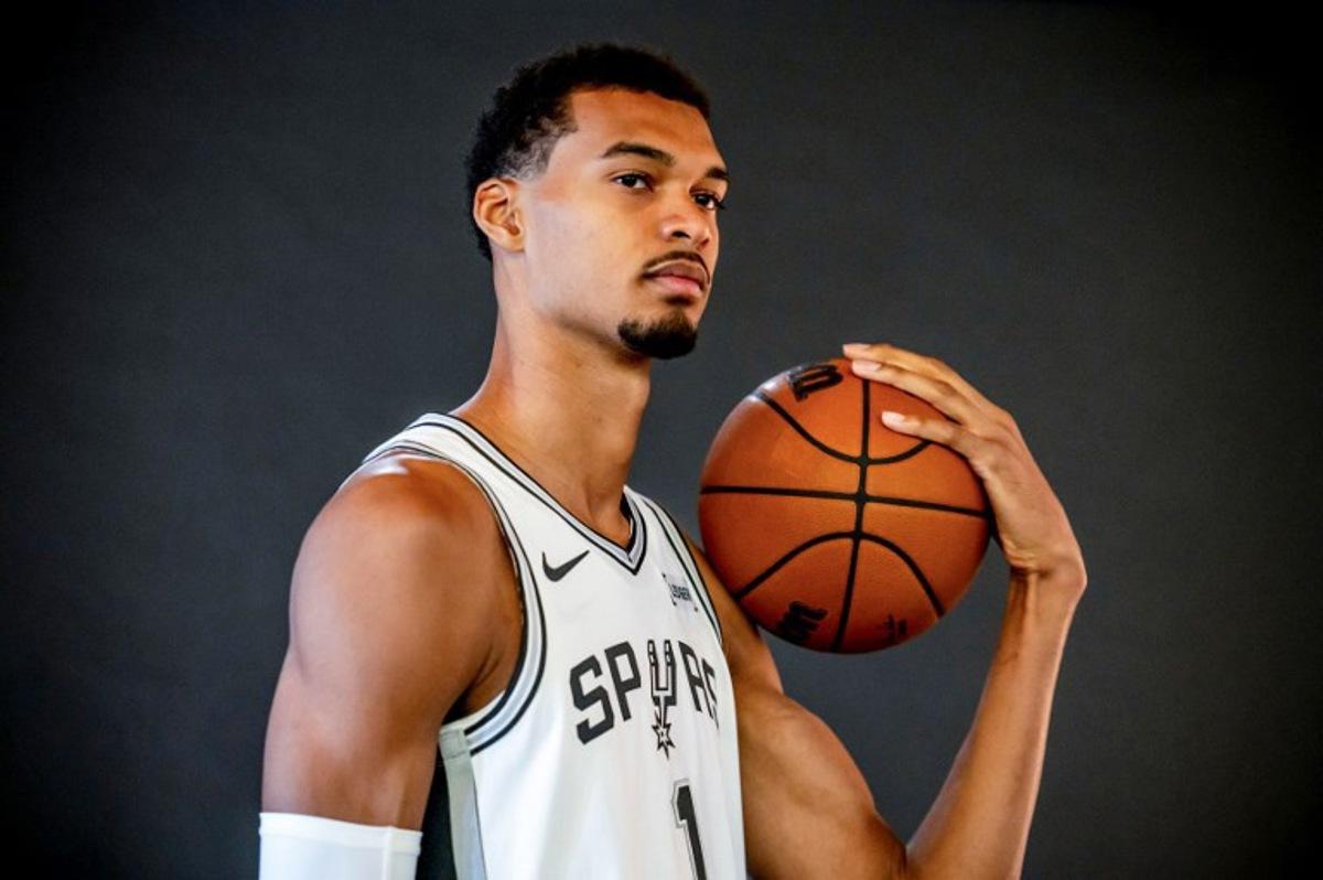 (FILES) French basketball player Victor Wembanyama poses for promotional photos during the San Antonio Spurs media day at the Victory Capital Performance Center in San Antonio, Texas on September 29, 2025. San Antonio Spurs superstar Victor Wembanyama said on January 27, 2026, he was "horrified" by unrest in Minneapolis, where two civilians have been shot dead by federal agents during the Trump administration's immigration crackdown.  SERGIO FLORES / AFP