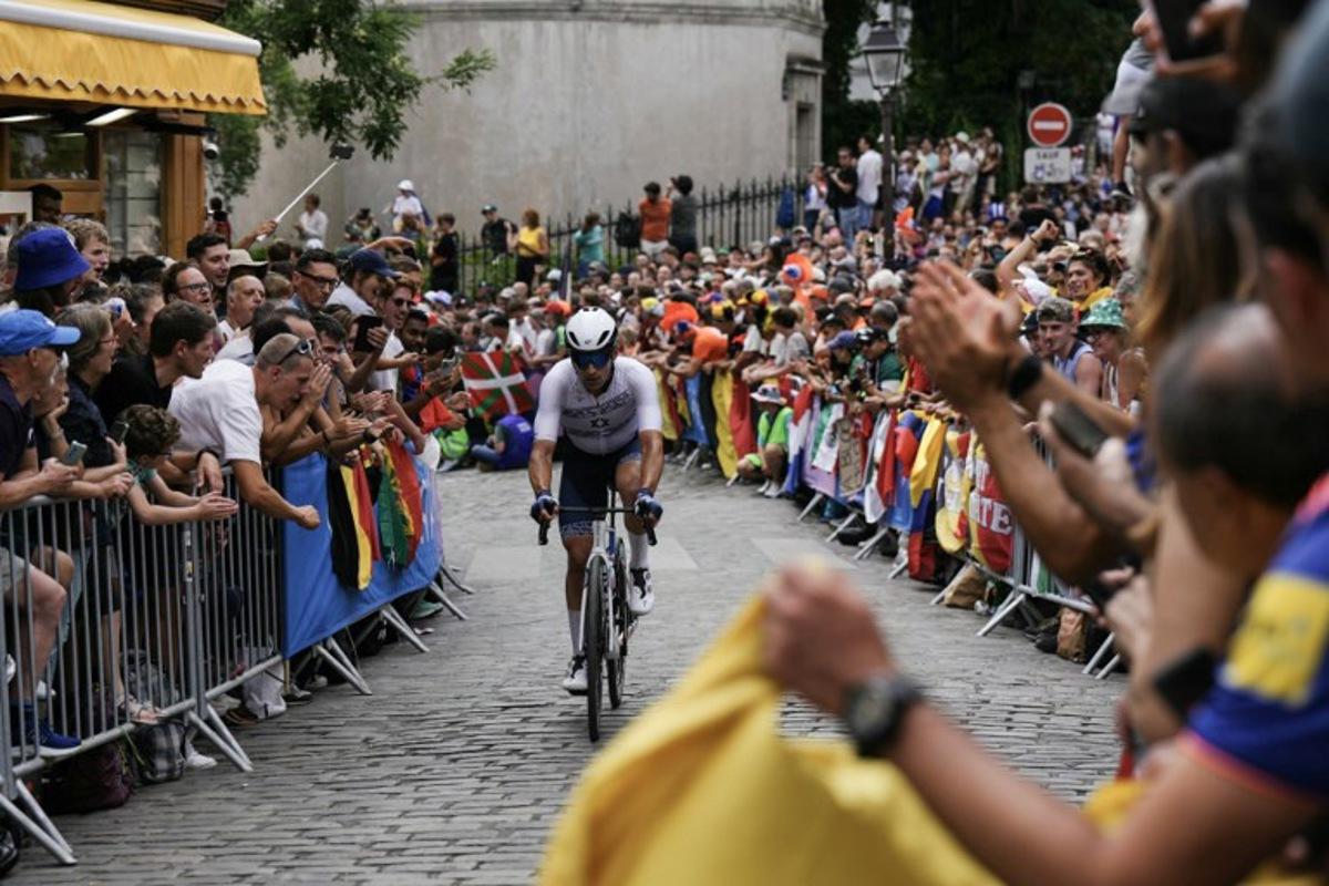 Israel's Itamar Einhorn cycles in Montmartre during the men's cycling road race during the Paris 2024 Olympic Games in Paris, on August 3, 2024.  Dimitar DILKOFF / AFP