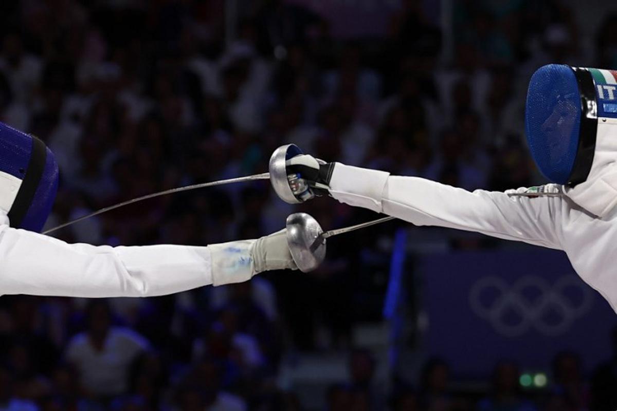 France's Coraline Vitalis (L) competes against Italy's Alberta Santuccio in the women's epee team gold medal bout during the Paris 2024 Olympic Games at the Grand Palais in Paris, on July 30, 2024.  Franck FIFE / AFP