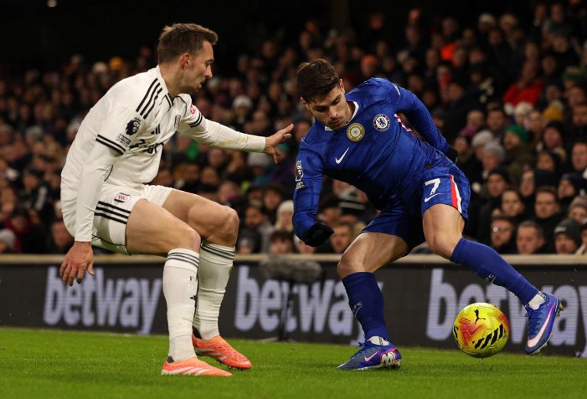 Fulham's Belgian defender #21 Timothy Castagne (L) vies with Chelsea's Portuguese midfielder #07 Pedro Neto during the English Premier League football match between Fulham and Chelsea at Craven Cottage in London on January 7, 2026.  Adrian Dennis / AFP