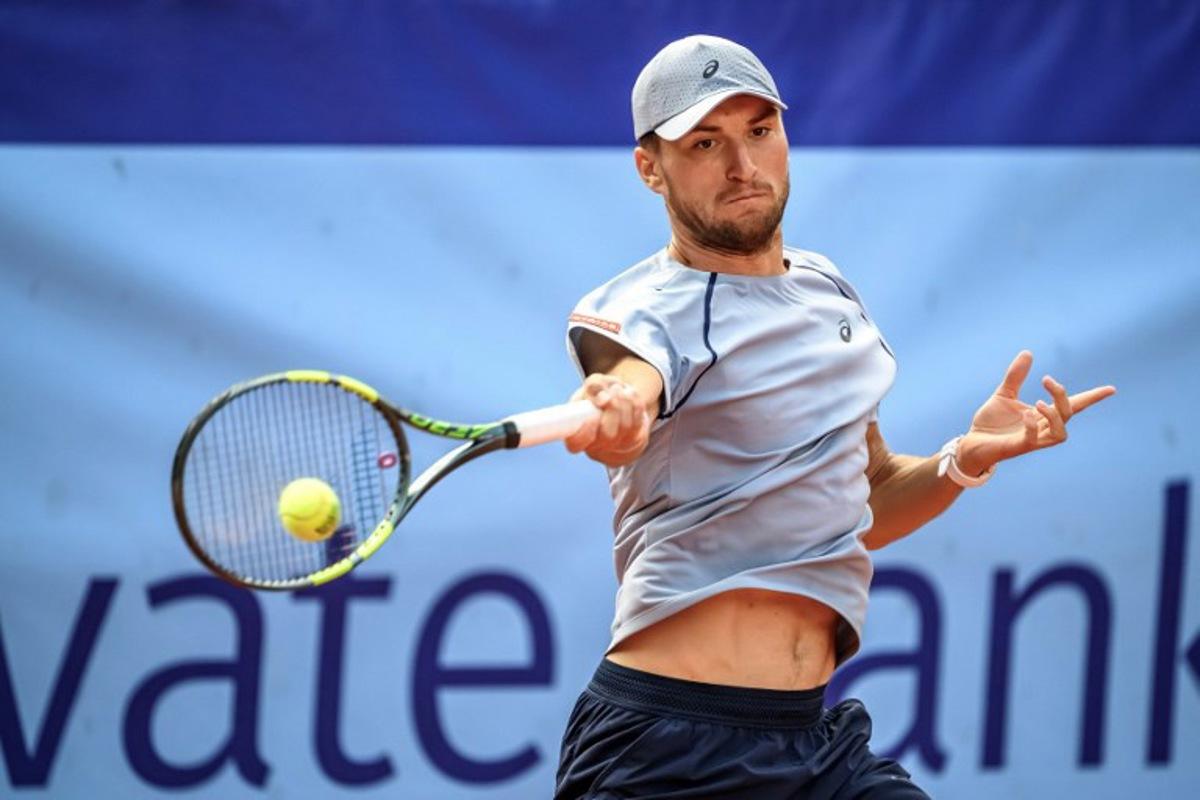 Belgium's Raphael Collignon returns the ball to Greece's Stefanos Tsitsipas during their men's singles final match at the Swiss Open tennis tournament in Gstaad, on July 19, 2026.  Fabrice COFFRINI / AFP